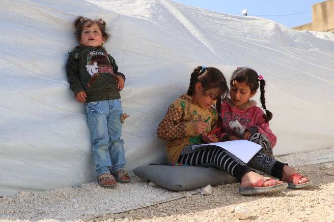 Girls gather beside tent